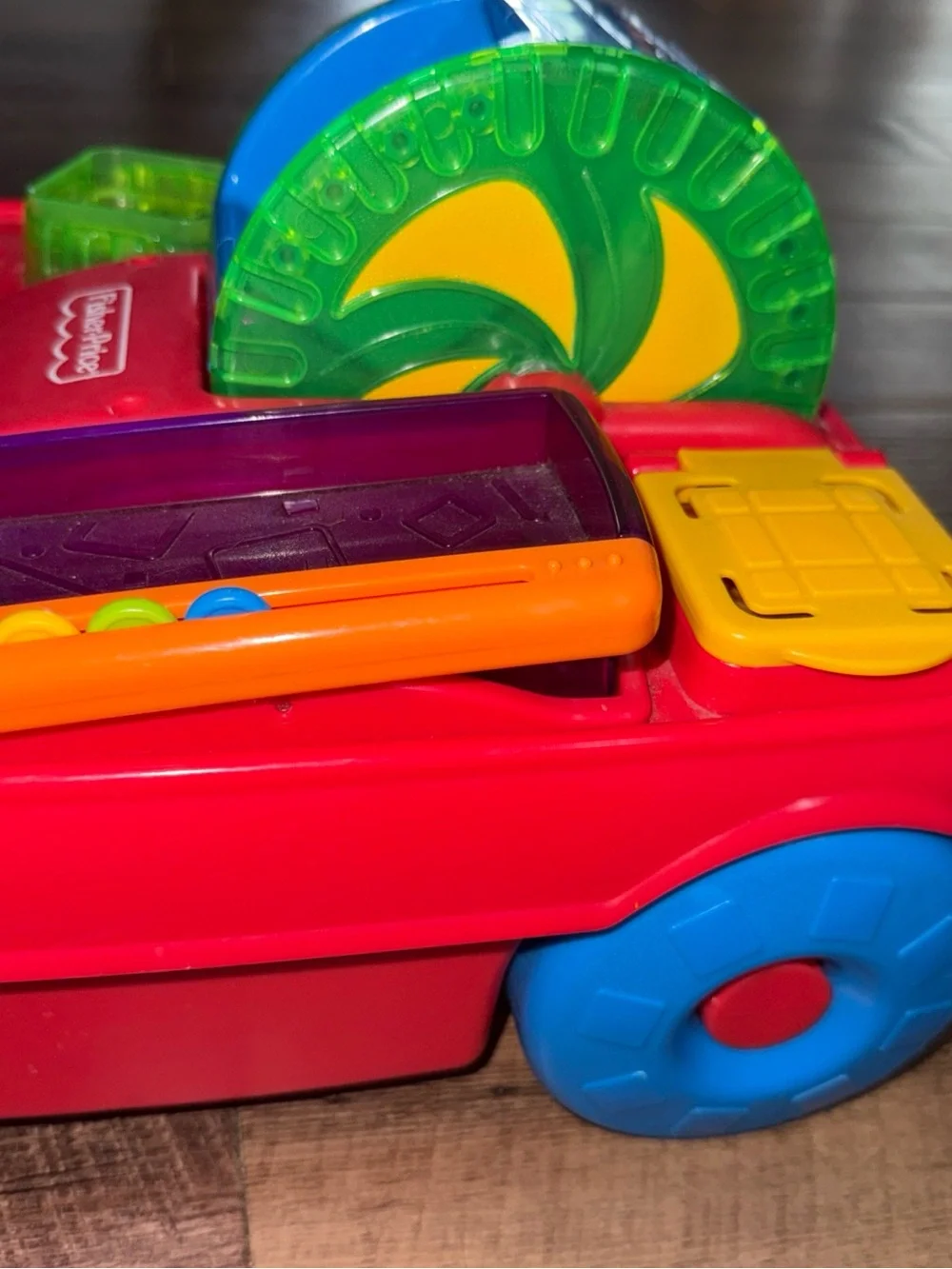 Vintage Fisher-Price Peek-a-boo Pull Toy with Green Handle and Blue Wheels